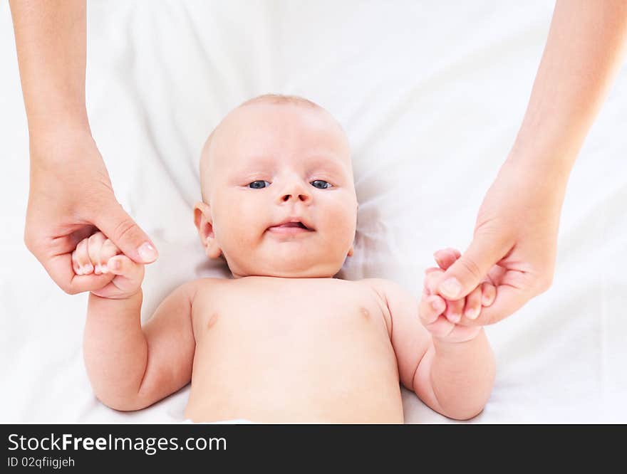 The parent holds for hands of the baby. Age - 3 months