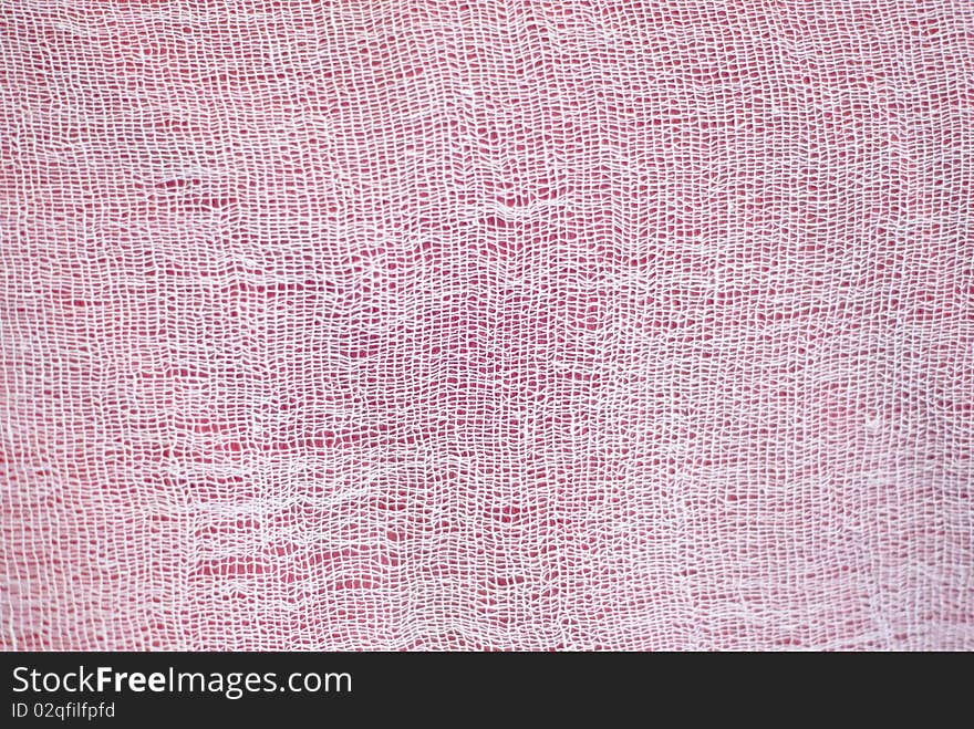 Background of white cotton mesh over red background