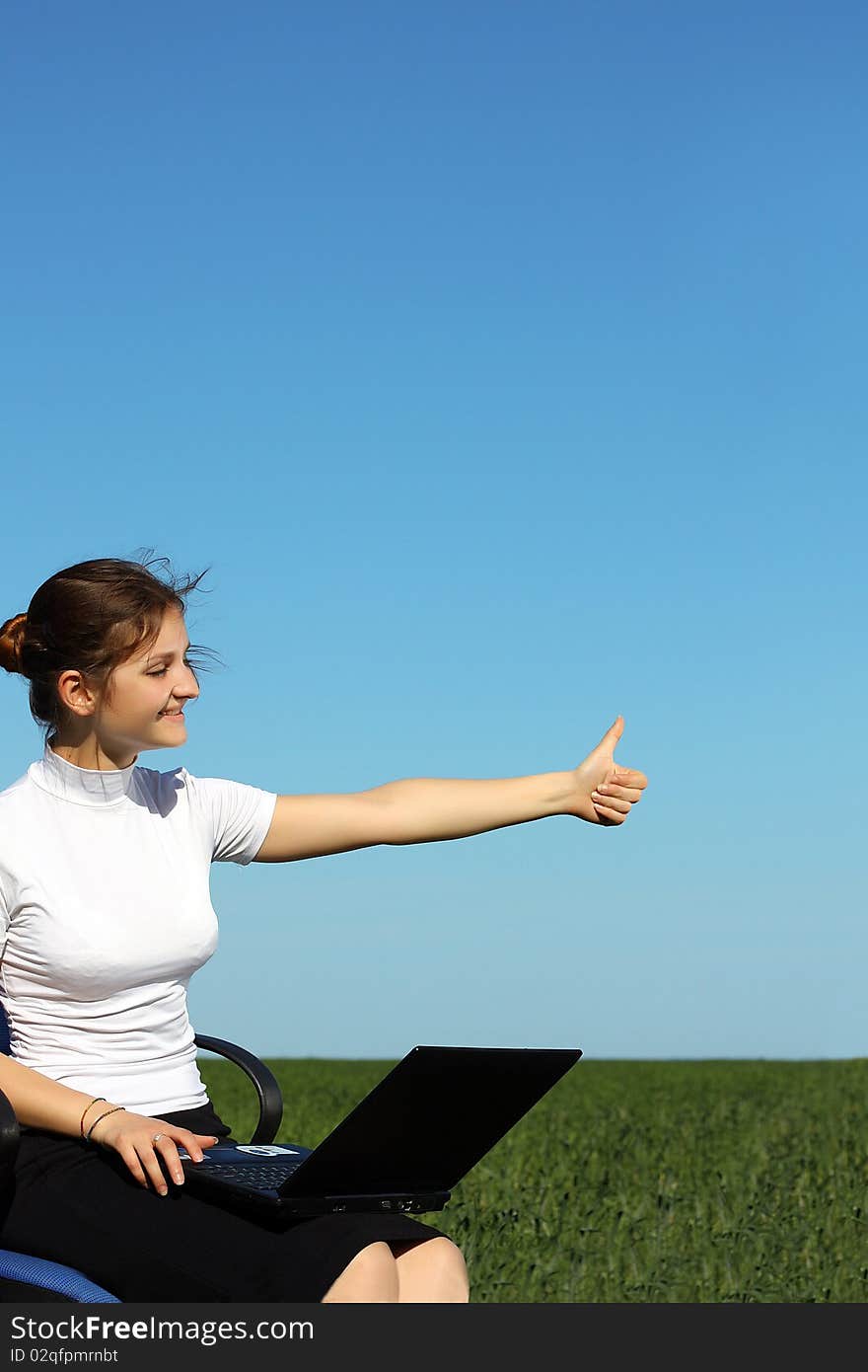 Pretty woman with laptop on the green grass. Pretty woman with laptop on the green grass