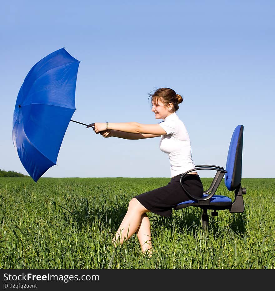 Businesswoman holding umbrella in park