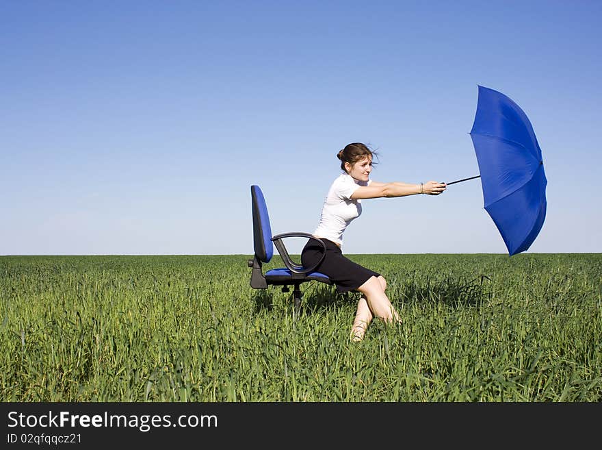 Young girl with an umbrella wind carries away