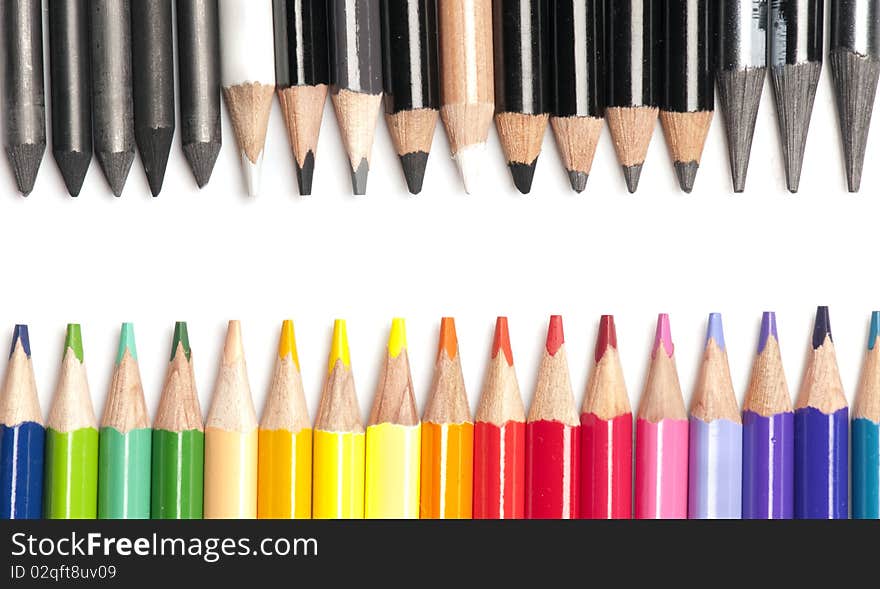 Collection of very brightly colored pencils opposing black and white pencils