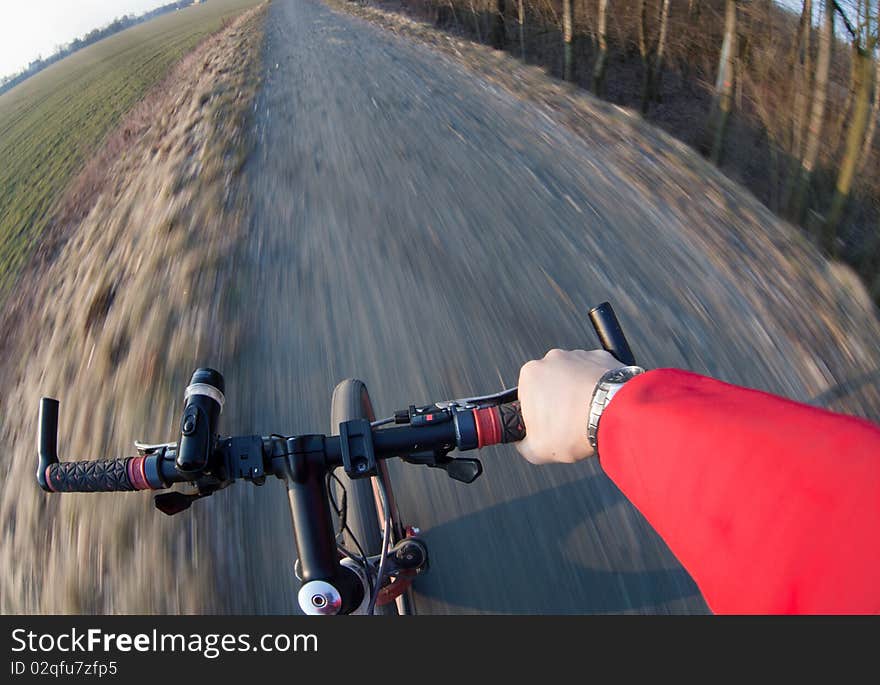 Riding a mountain bicycle on a country road (motion blurred image)