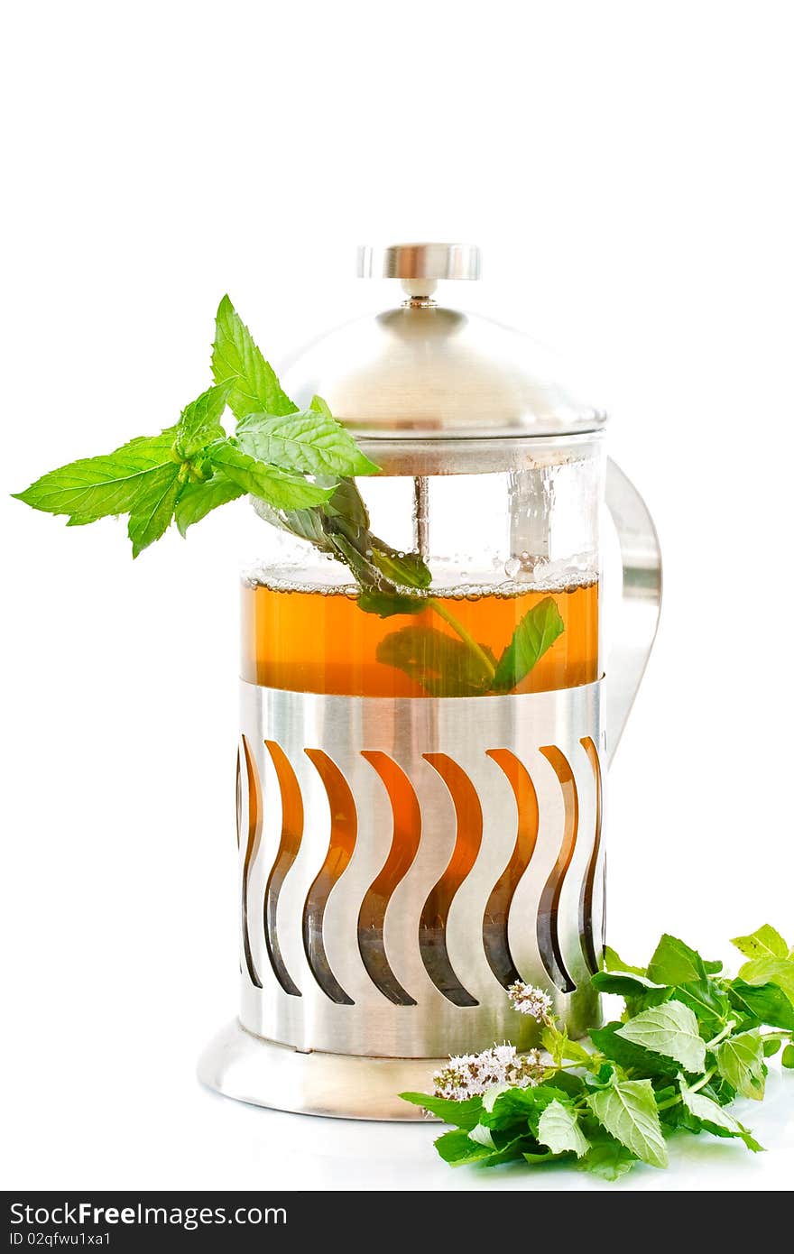 Mint tea in a teapot and a bundle of mint