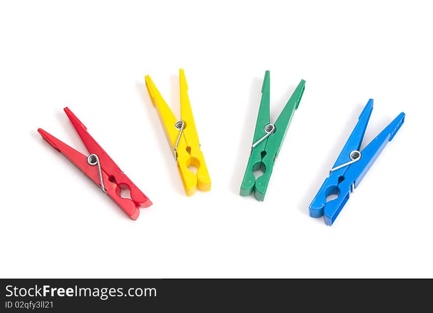 Color clothes pegs on a white background