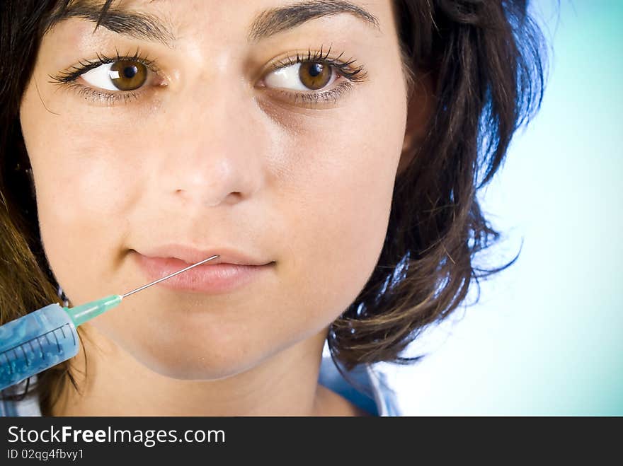 Beautiful woman recieving a botox injection in her lip