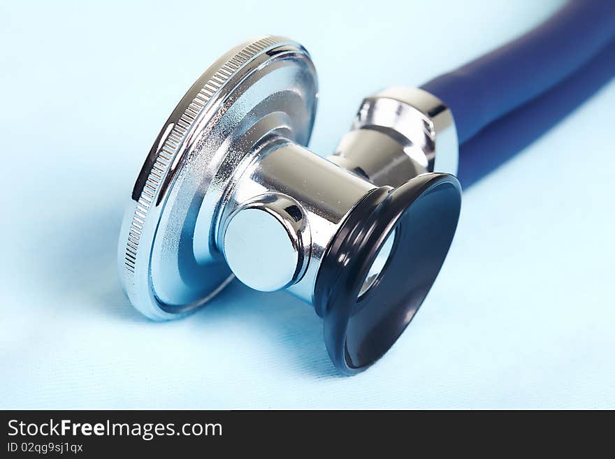 Medical stethoscope over blue background . Close up