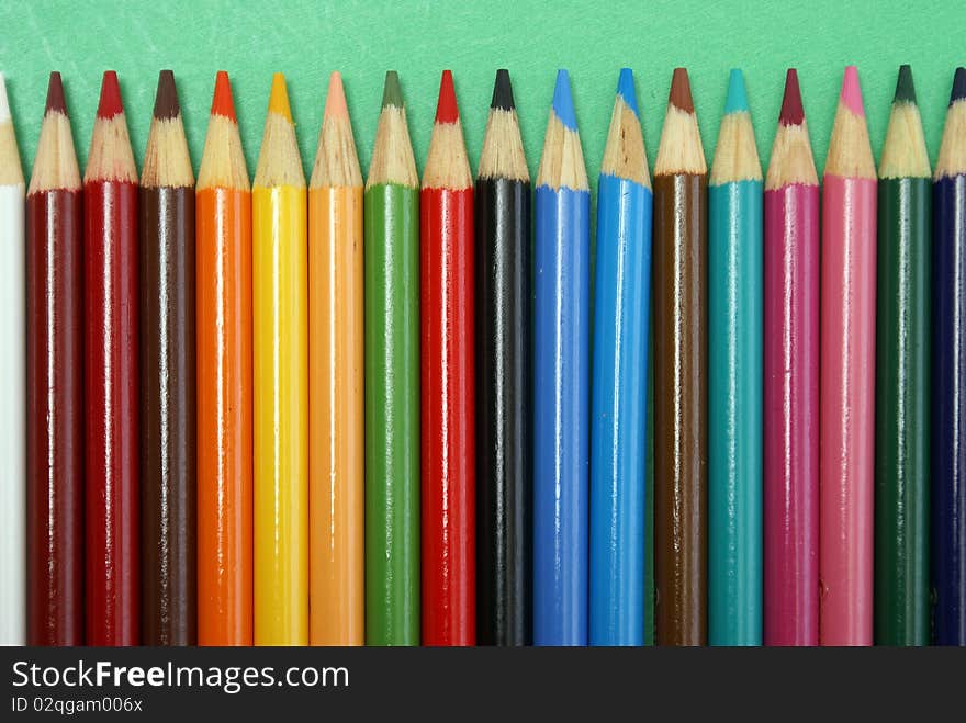 A row of various colored pencil crayons. A row of various colored pencil crayons.