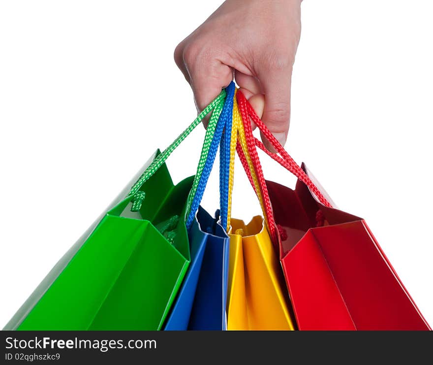 A hand is holding a shopping bag - isolated on a white background