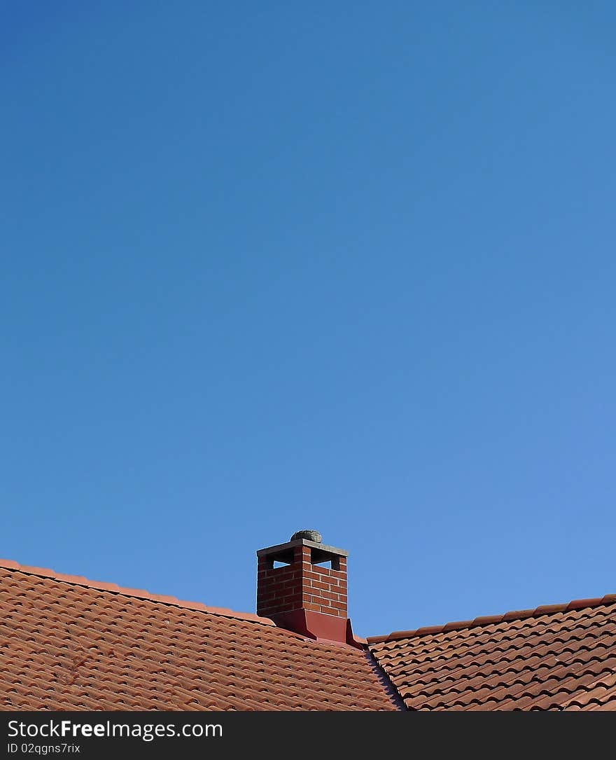 Roof top with chimney and a blue sky. Room for text. Stockholm, Sweden.