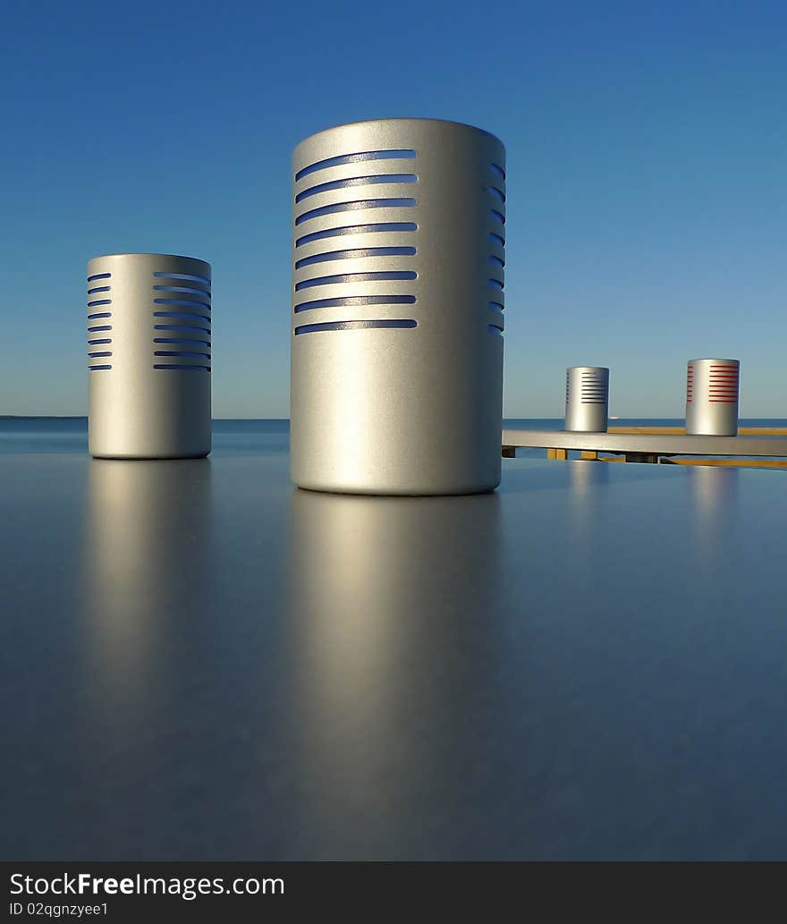 Candle light holders on a plain surface outdoor by the sea and with blue sky. Sweden