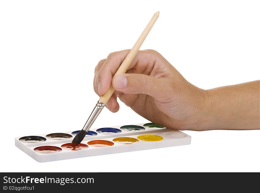 Watercolors and hand with a paintbrush on a white background