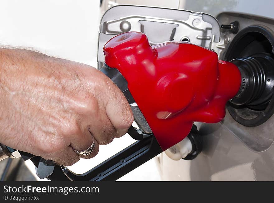 Close-up of hand refueling at gas pump. Close-up of hand refueling at gas pump