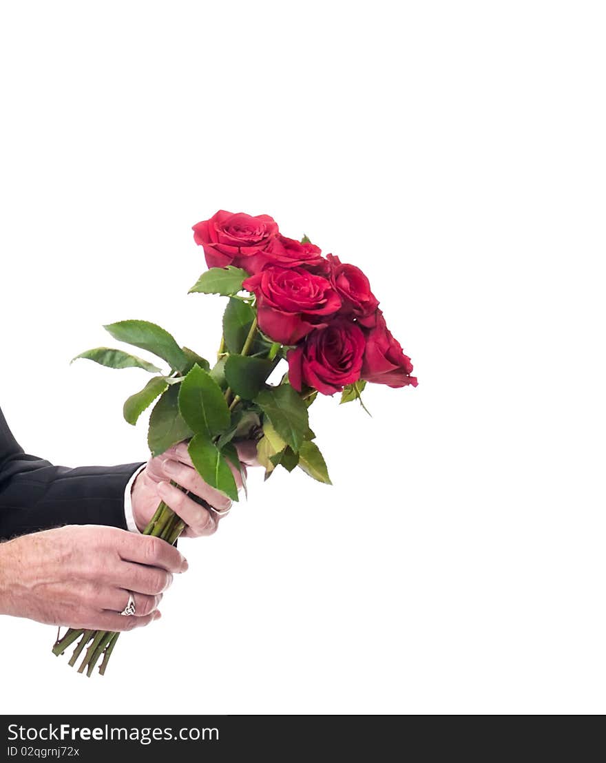 Male hands holding out beautiful bunch of red roses as Valentine's. anniversary, or birthday gift. Romantic gesture. Male hands holding out beautiful bunch of red roses as Valentine's. anniversary, or birthday gift. Romantic gesture.