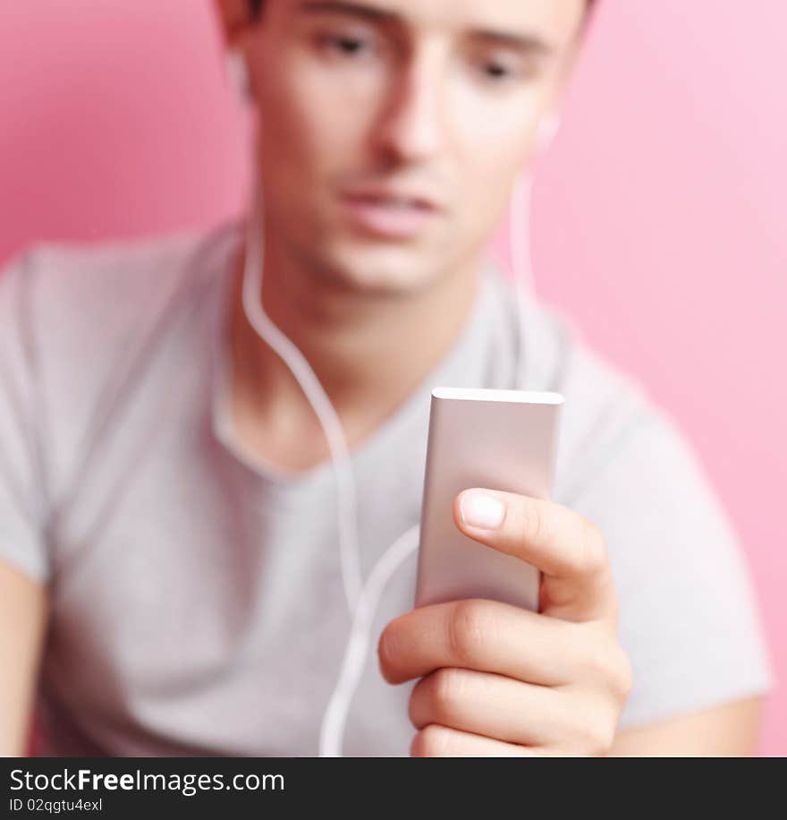 Young handsome man listening to the music