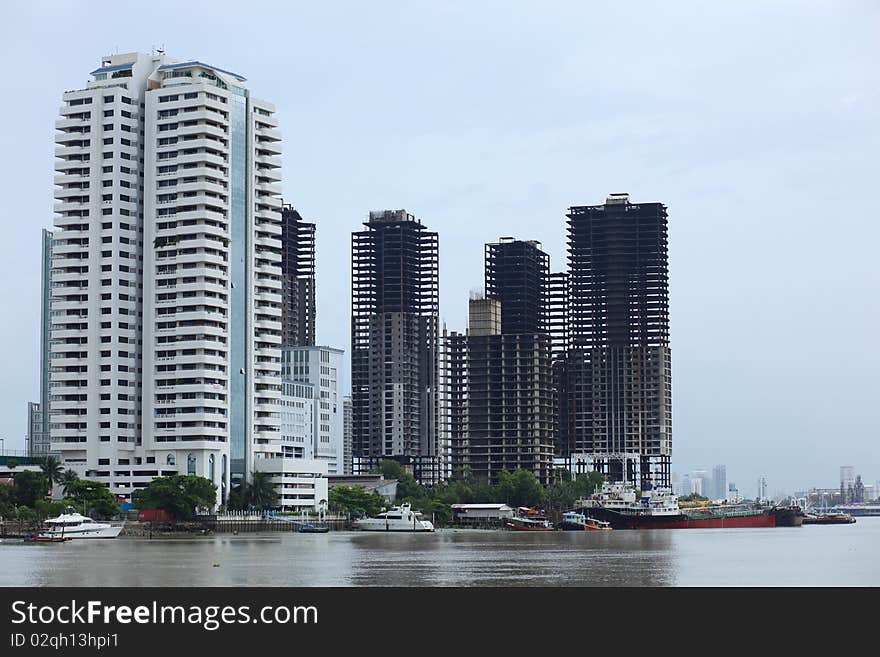 Buildings near Chao Phara River, Bangkok, Thailand. One big alive building, and some smaller abandoned building nearby. Buildings near Chao Phara River, Bangkok, Thailand. One big alive building, and some smaller abandoned building nearby.