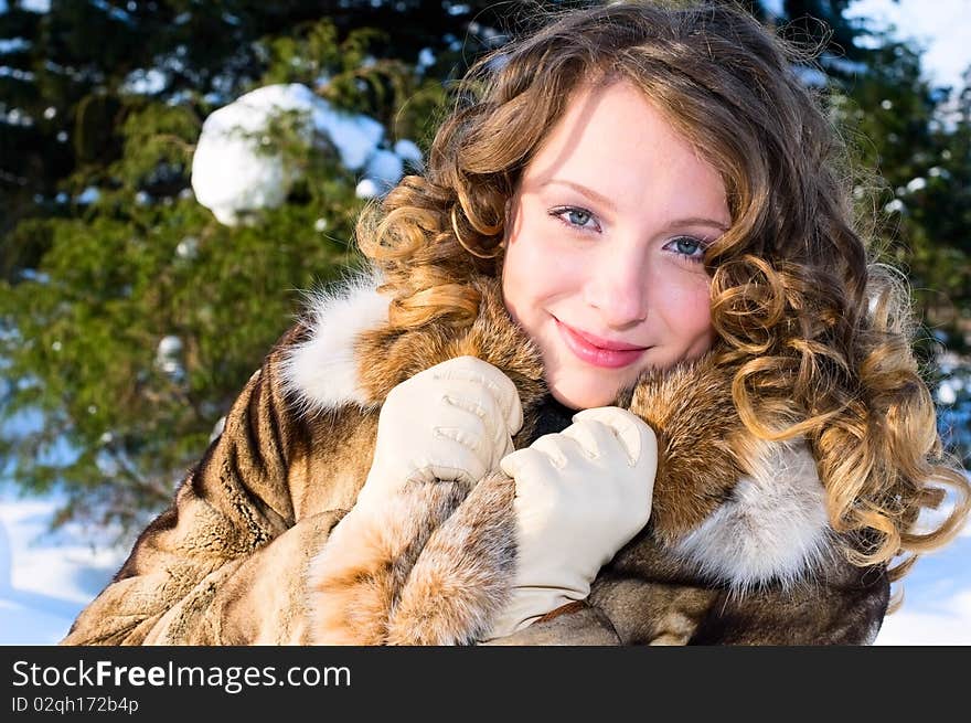 Pretty girl in winter forest