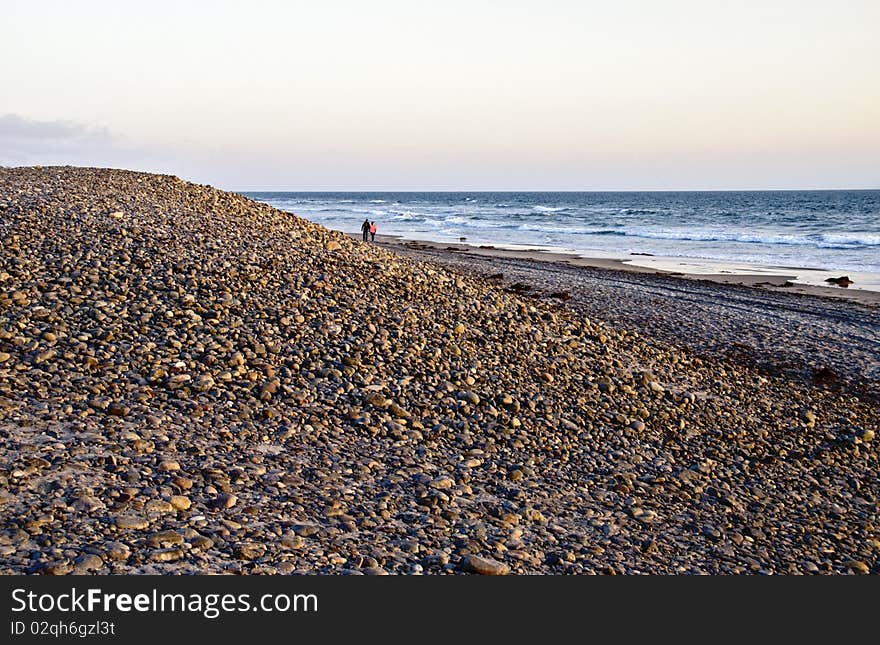 Evening walk on a pebbly beach