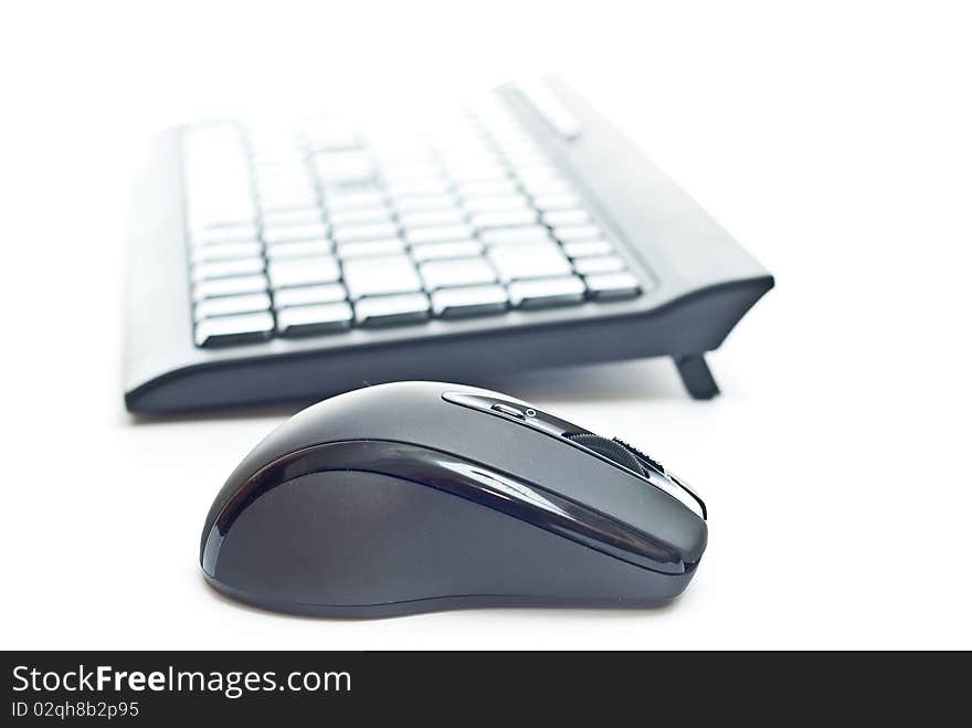 Black pc keyboard and mouse isolated on white. Focus on mouse