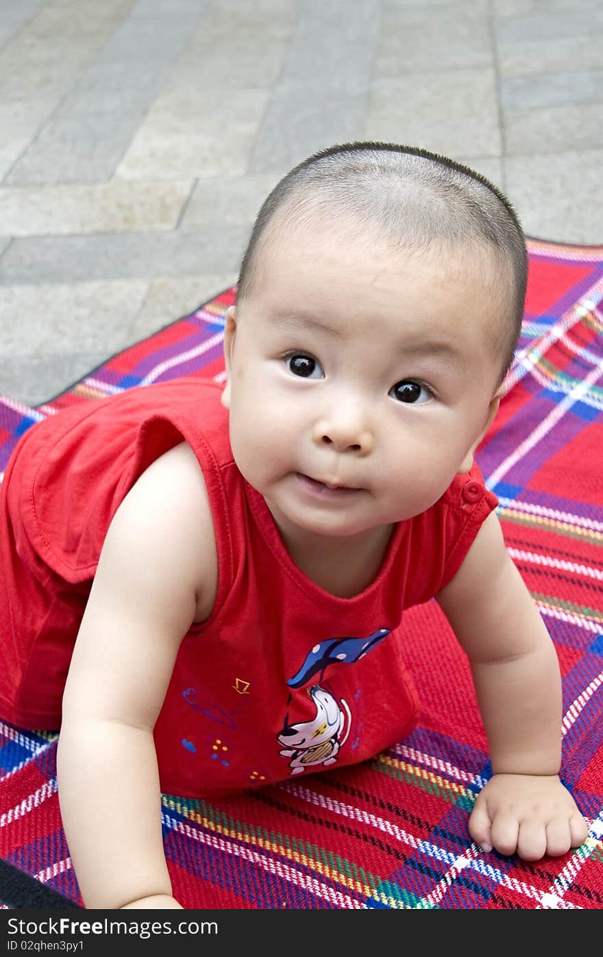 A cute playing baby in a park