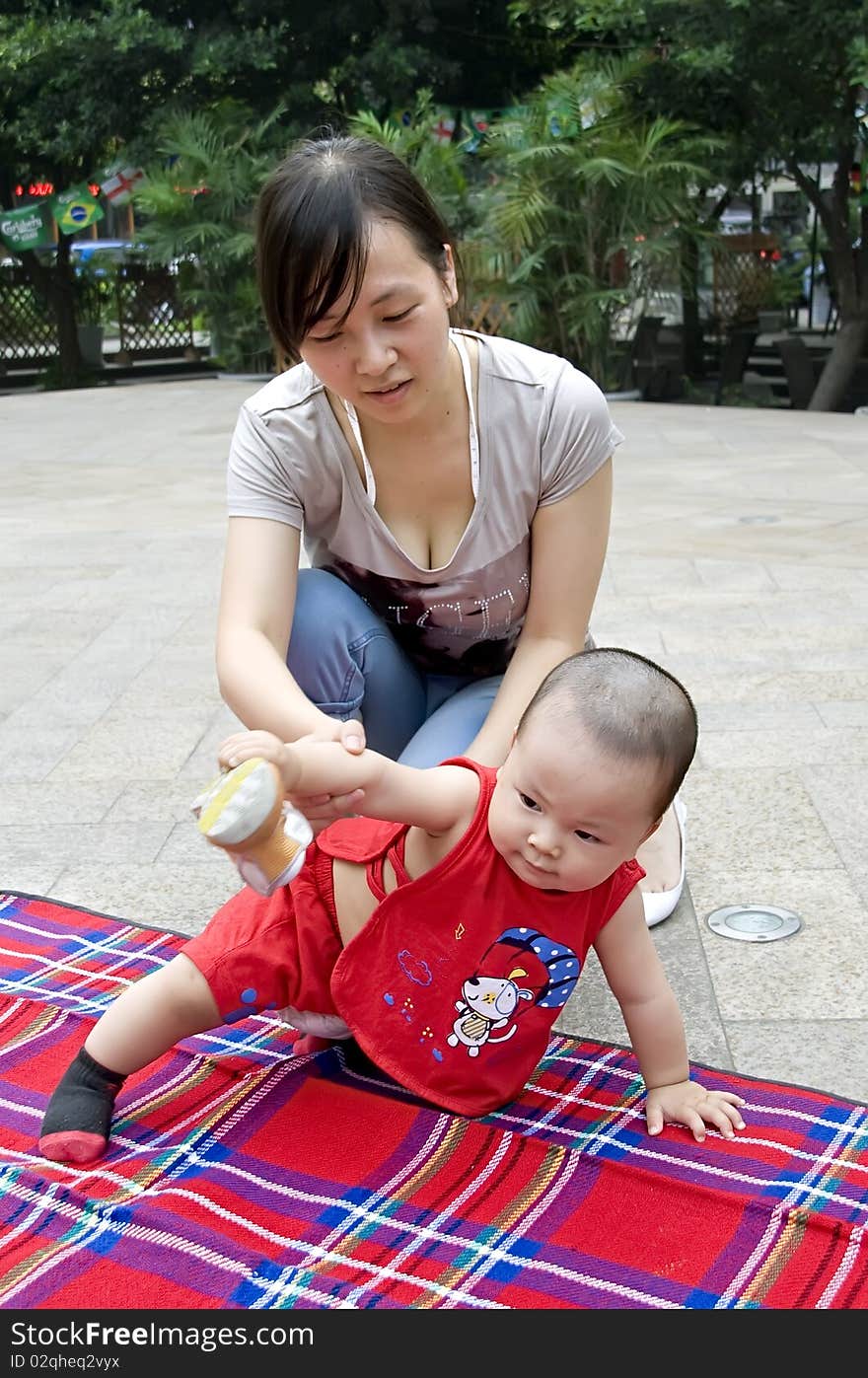 Hapy baby with his mother in garden