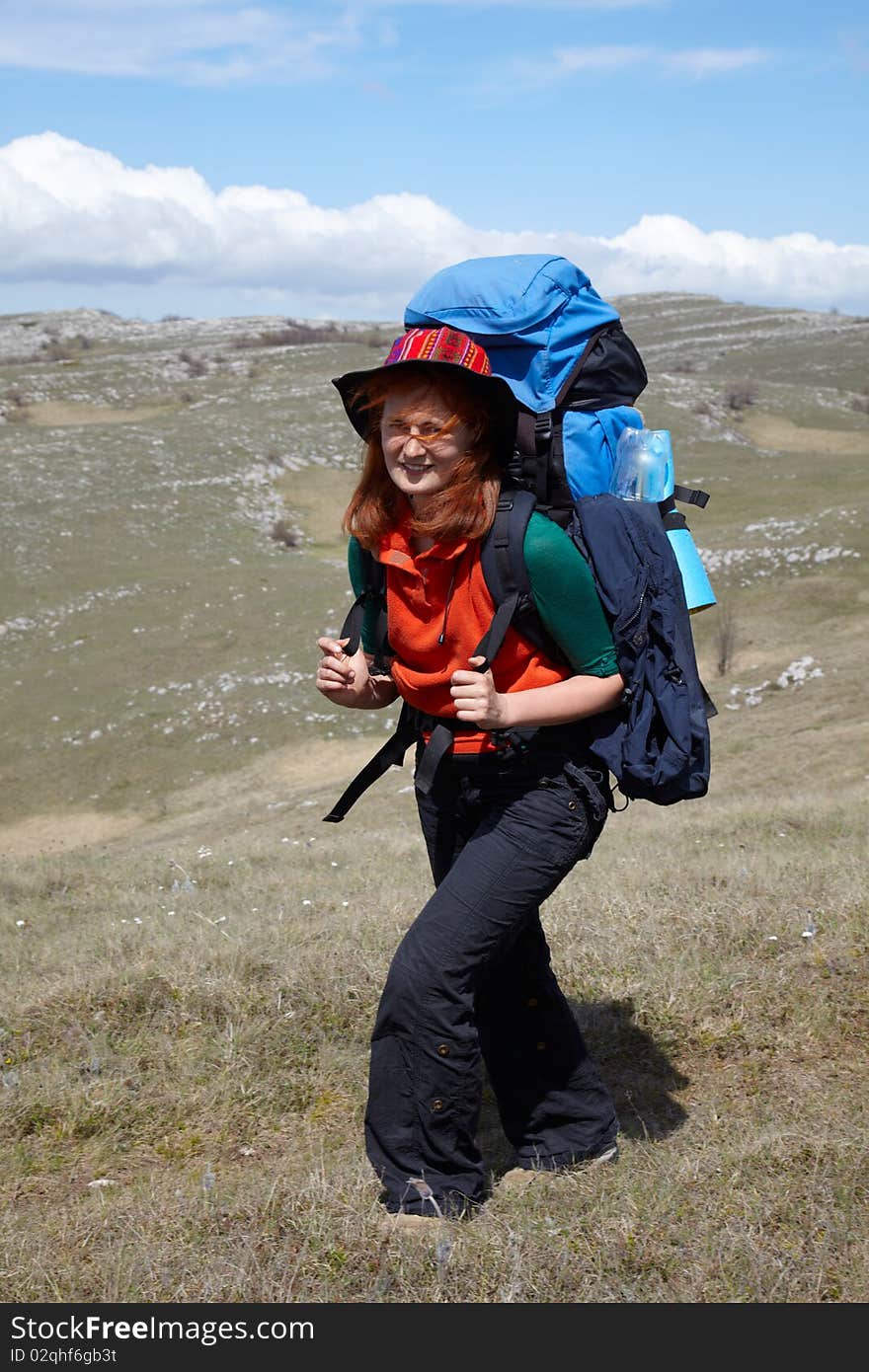 Red haired hiker with blue backpack