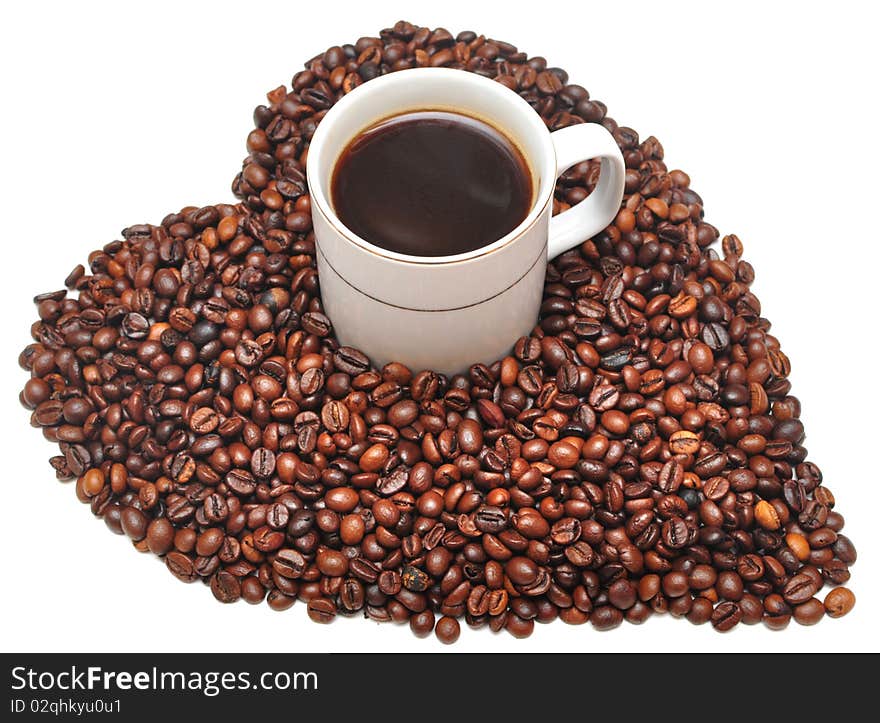 Cup of coffee with heart shaped sign from coffee beans