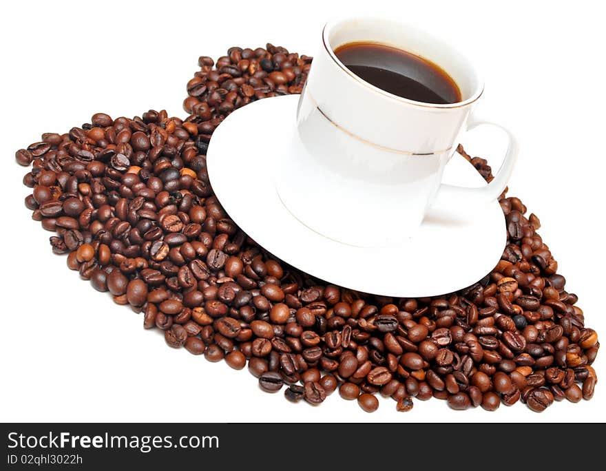 Cup of coffee with heart shaped sign from coffee beans