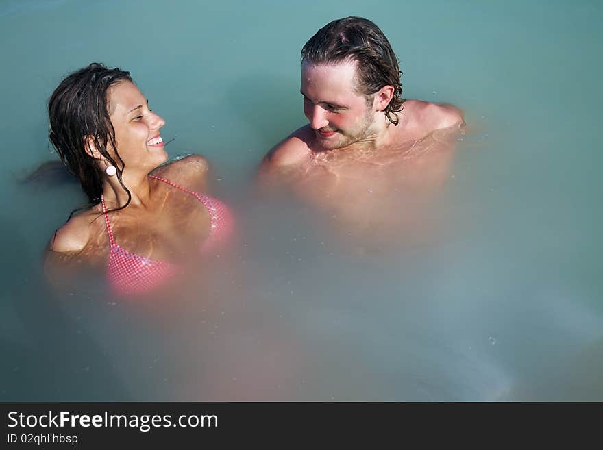 Man and woman have good time in open water on resort. Man and woman have good time in open water on resort