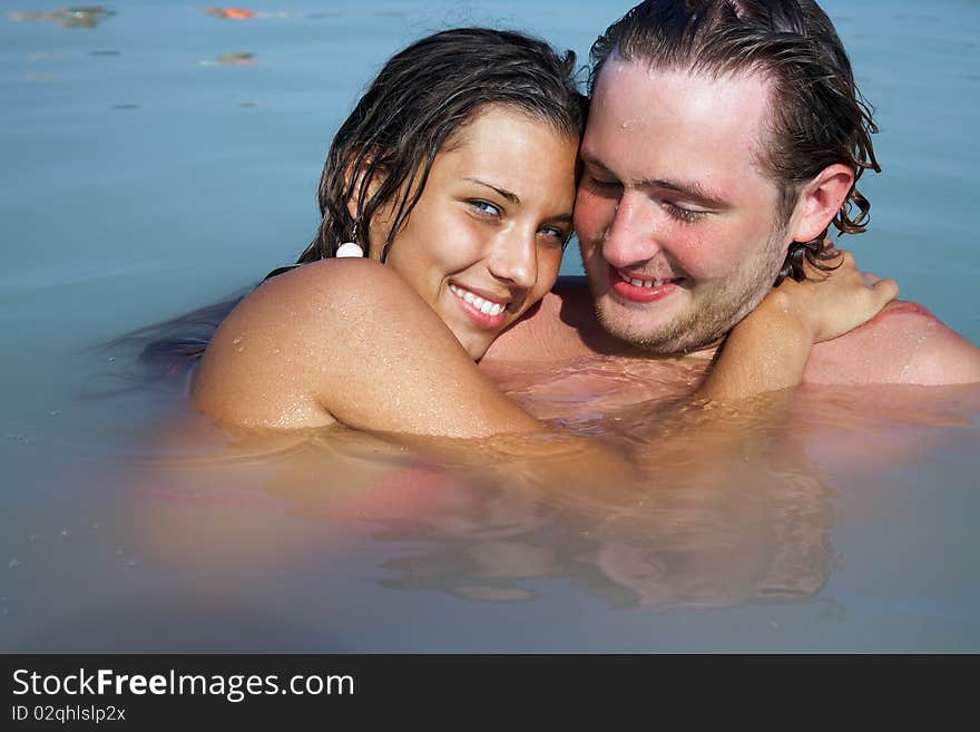 Photo of young man and woman together in open water on resort. Photo of young man and woman together in open water on resort