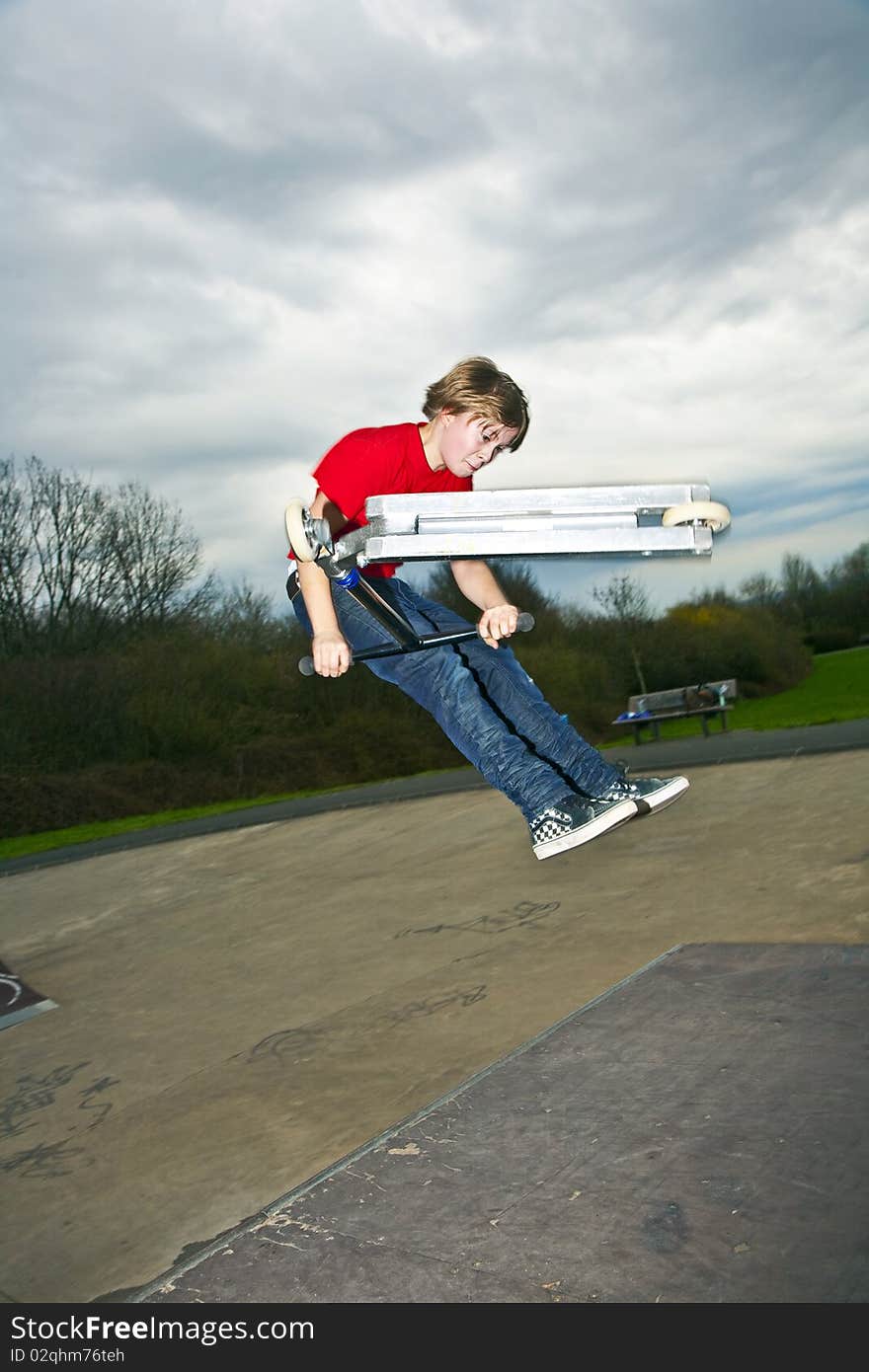 Boy going airborne with a scooter