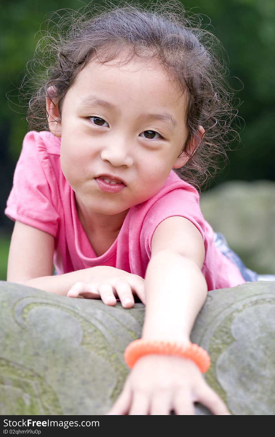 A happy little girl in a garden