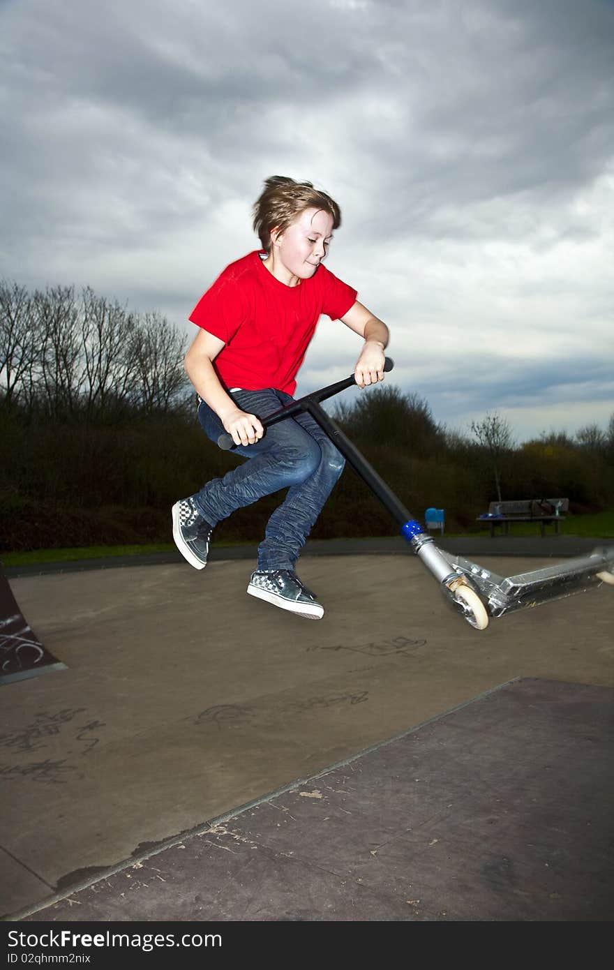 Boy Going Airborne With A Scooter