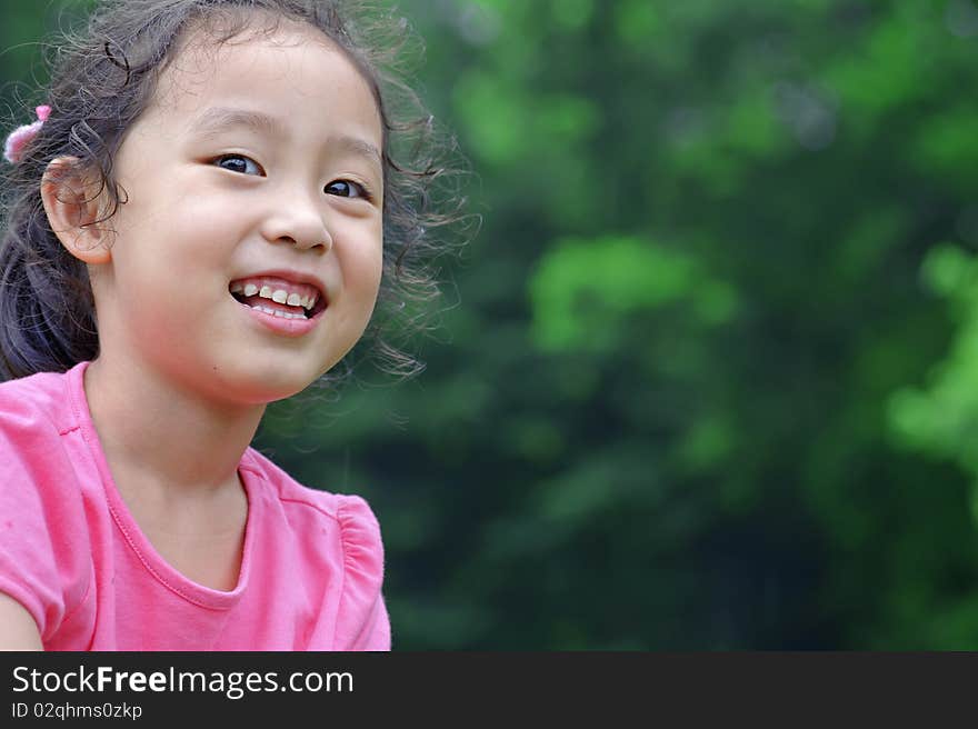 Happy little girl in a garden