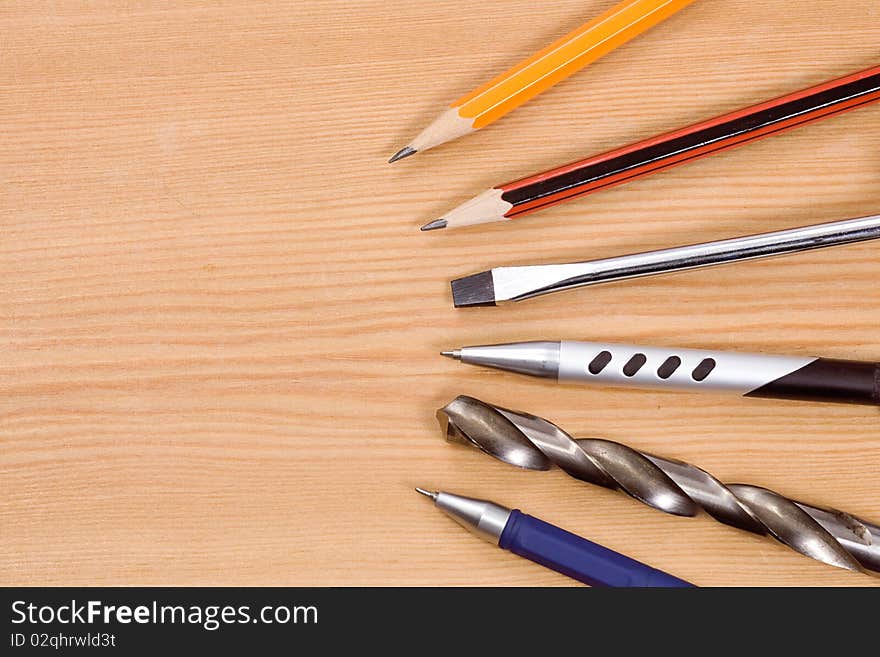 Tools, pencil and pens at table