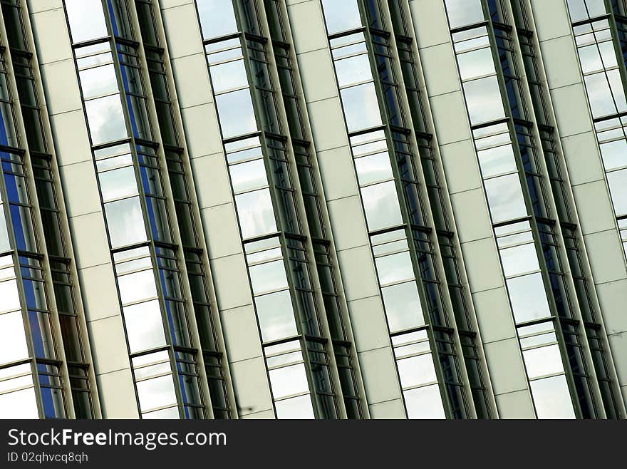 Tilted building feature with sparkling glass curtain wall