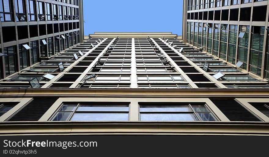 Tilted building feature with sparkling glass curtain wall