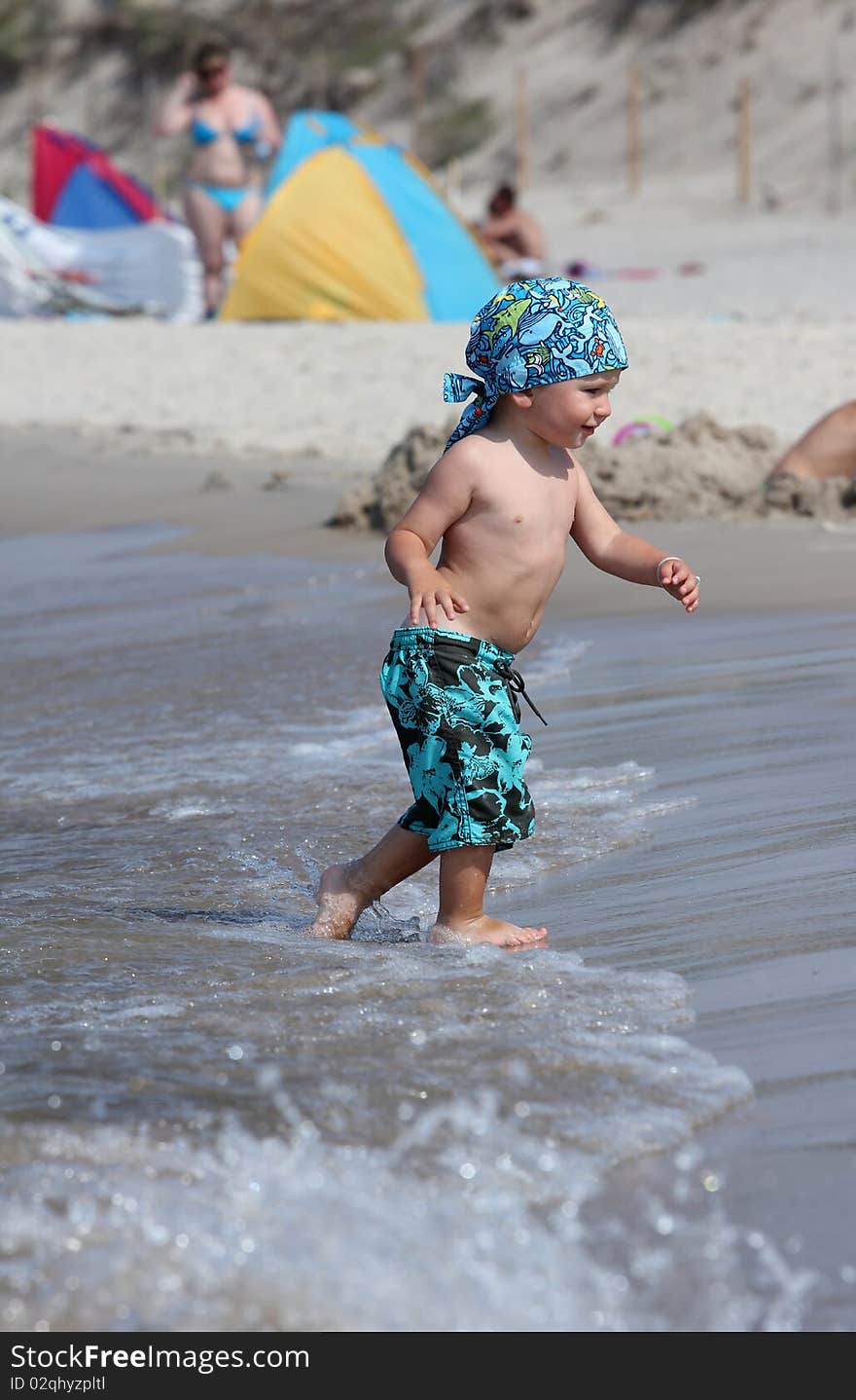 Child, water and fun. Baby boy have fun. Two years old baby boy on the beach. Child, water and fun. Baby boy have fun. Two years old baby boy on the beach.