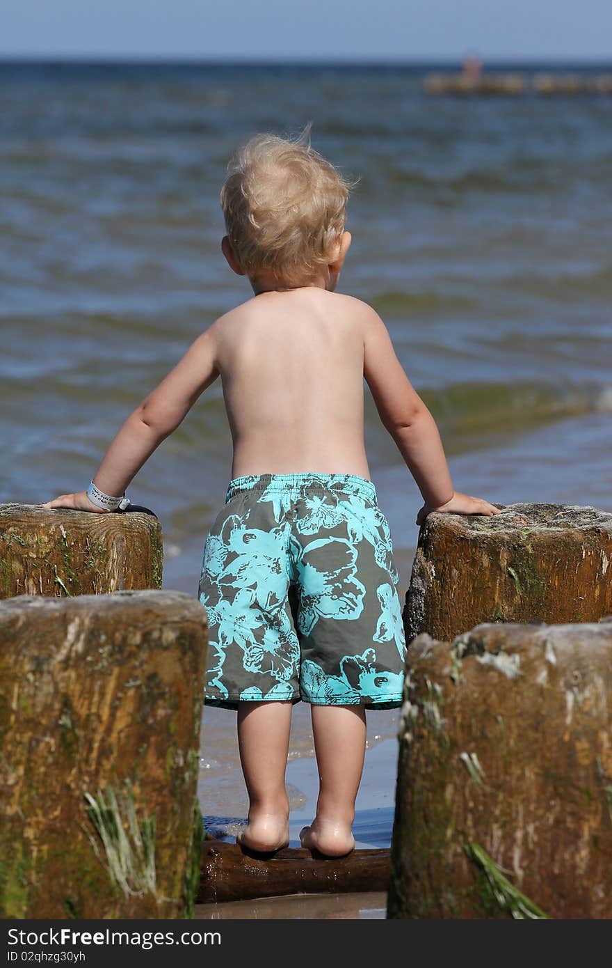 Child, water and fun. Baby boy have fun. Two years old baby boy on the beach. Child, water and fun. Baby boy have fun. Two years old baby boy on the beach.