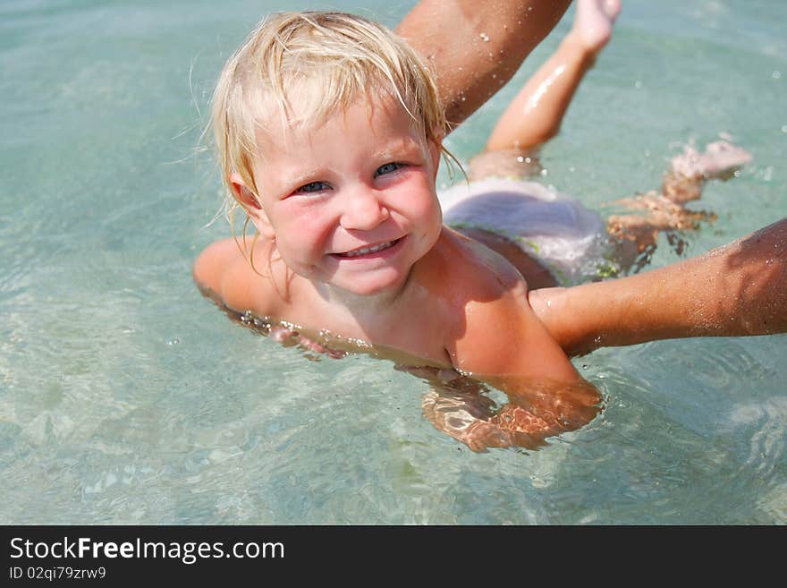 Portrait of happy baby swimming