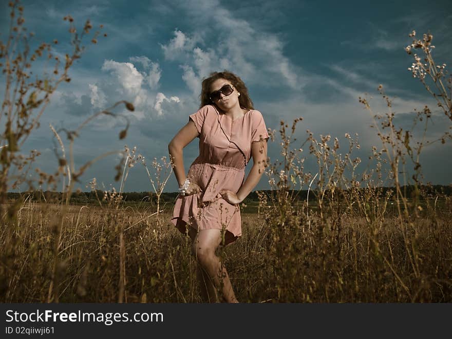 Young woman in sunglasses at summer meadow plants. Young woman in sunglasses at summer meadow plants