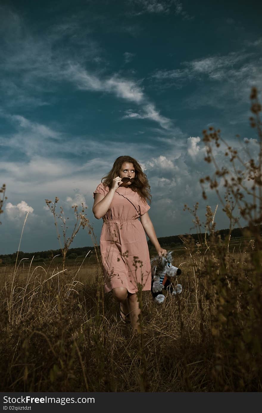 Young woman in sunglasses walking through meadow plants. Young woman in sunglasses walking through meadow plants