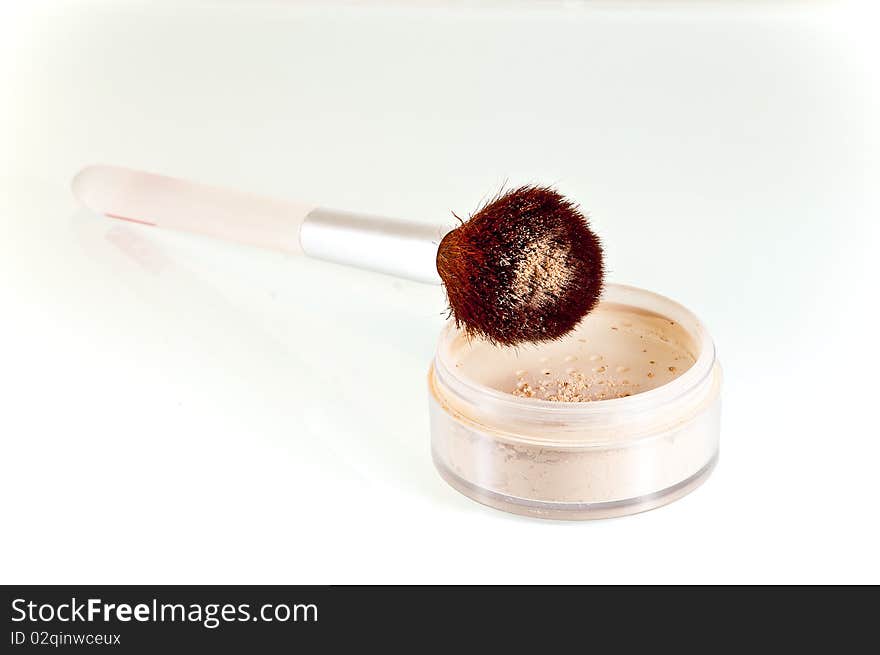 Stylish glass makeup brush in cosmetic pouder