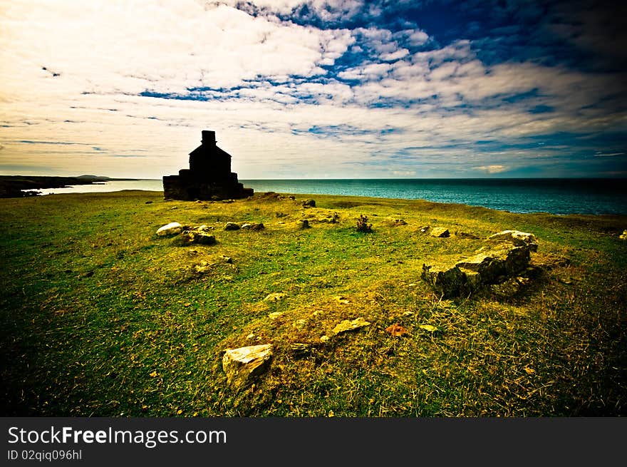 Welsh coastline with old house ruin on foreground