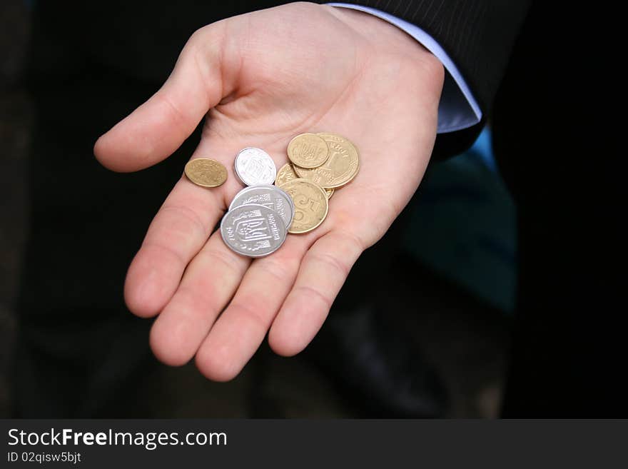 Macro view of different coins in a man's hand. Macro view of different coins in a man's hand