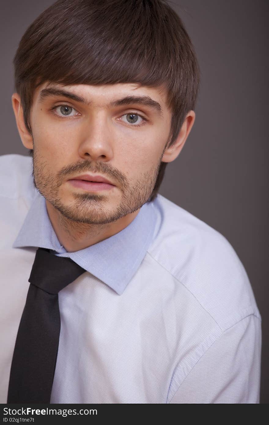 Portrait of businessman in shirt and tie on grey background. Portrait of businessman in shirt and tie on grey background