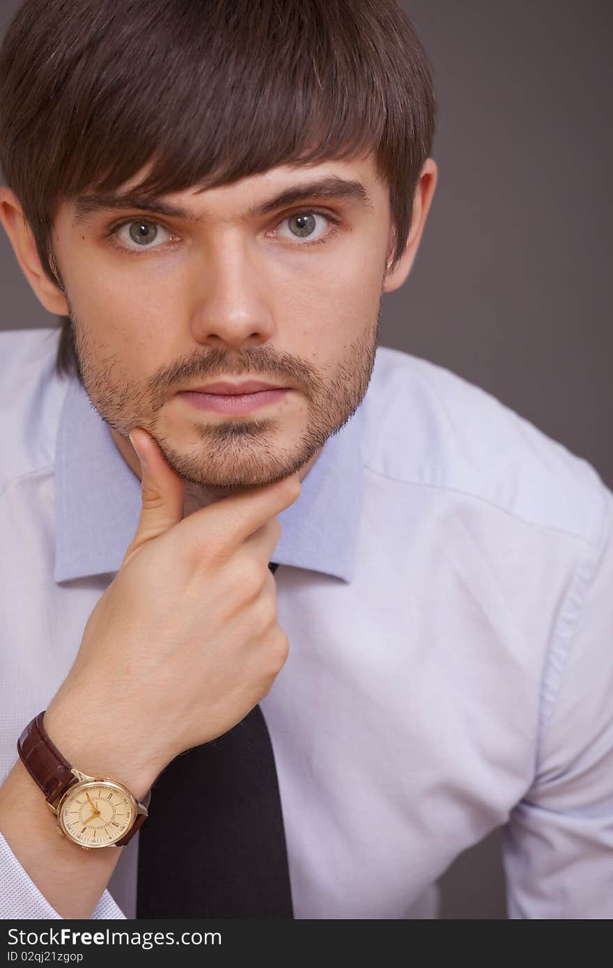 Portrait of handsome man in studio on grey background