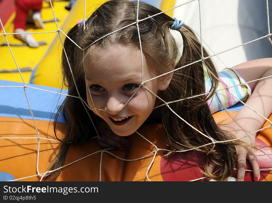 The little girl close up is amused with other children, a protection. The little girl close up is amused with other children, a protection