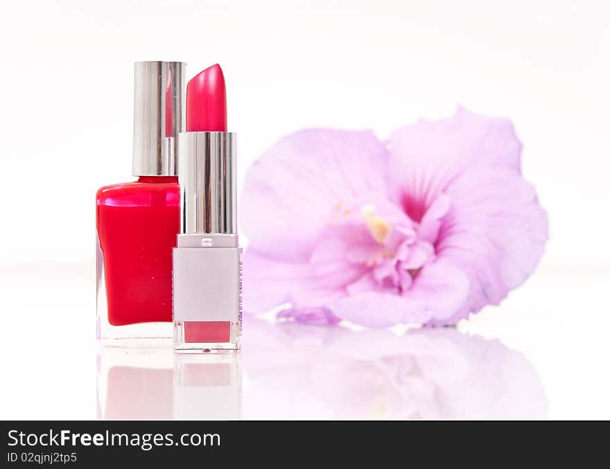 Lipstick and Nail Polish with Flower in Background. Lipstick and Nail Polish with Flower in Background