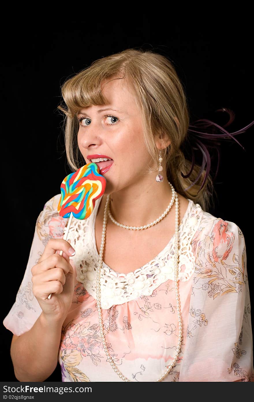 Women licking lollypop, vintage stile, black background. Women licking lollypop, vintage stile, black background